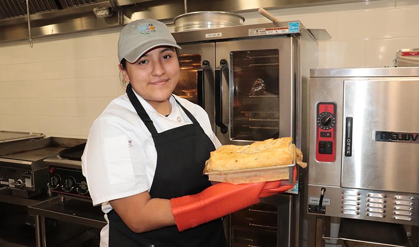 Culinary Arts student showing her culinary dish.